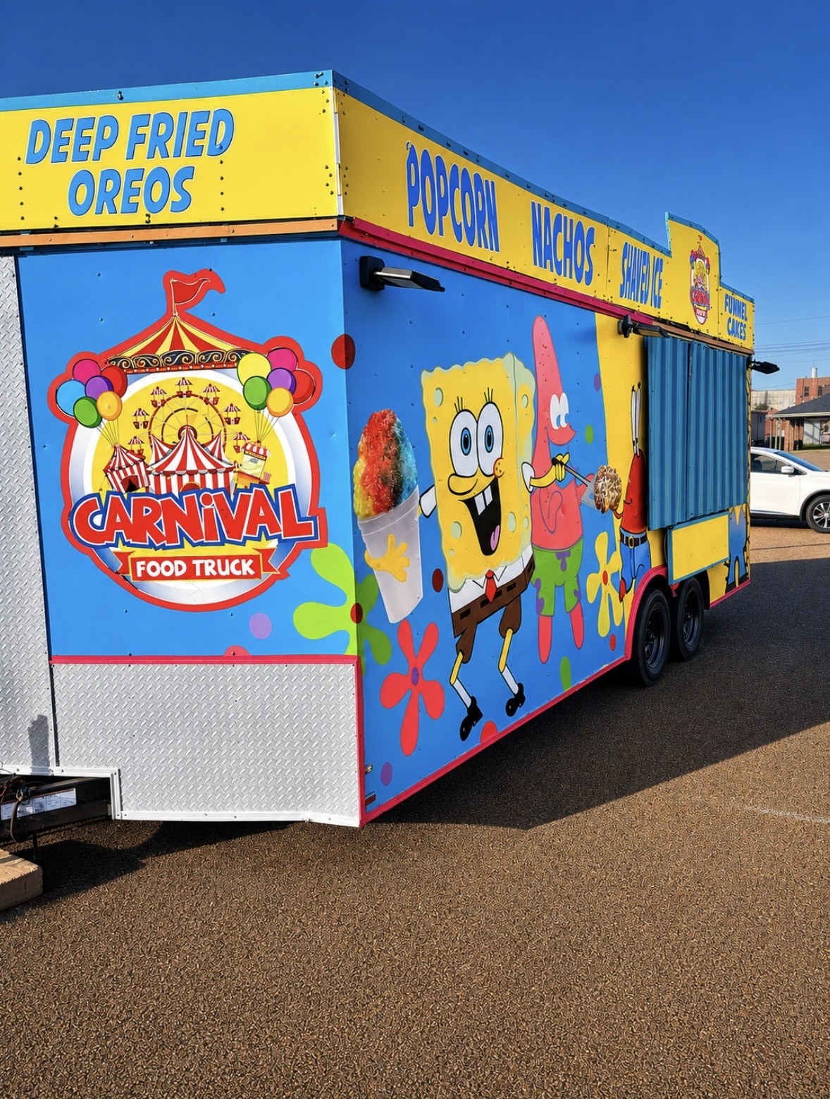 Carnival Treats Express colorful blue and yellow food trailer, available for event booking